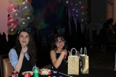 students smiling and eating at the party