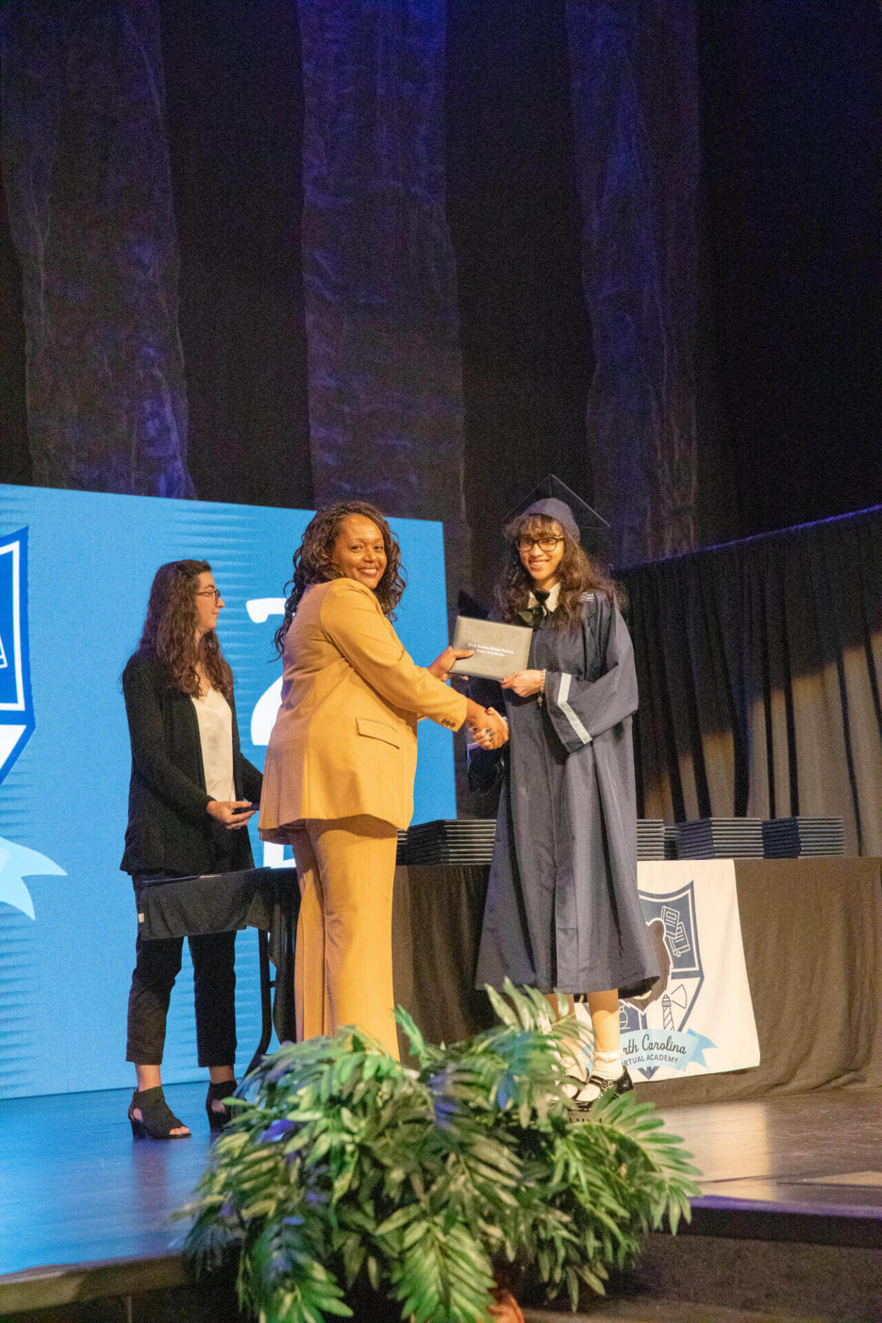 student girl with director and diploma