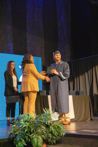 boy student with principal and diploma