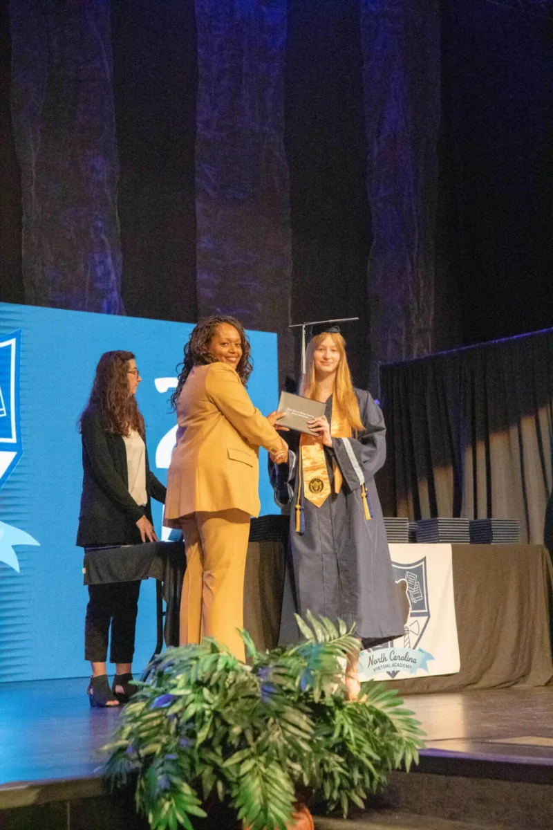 student receiving a diploma from principal