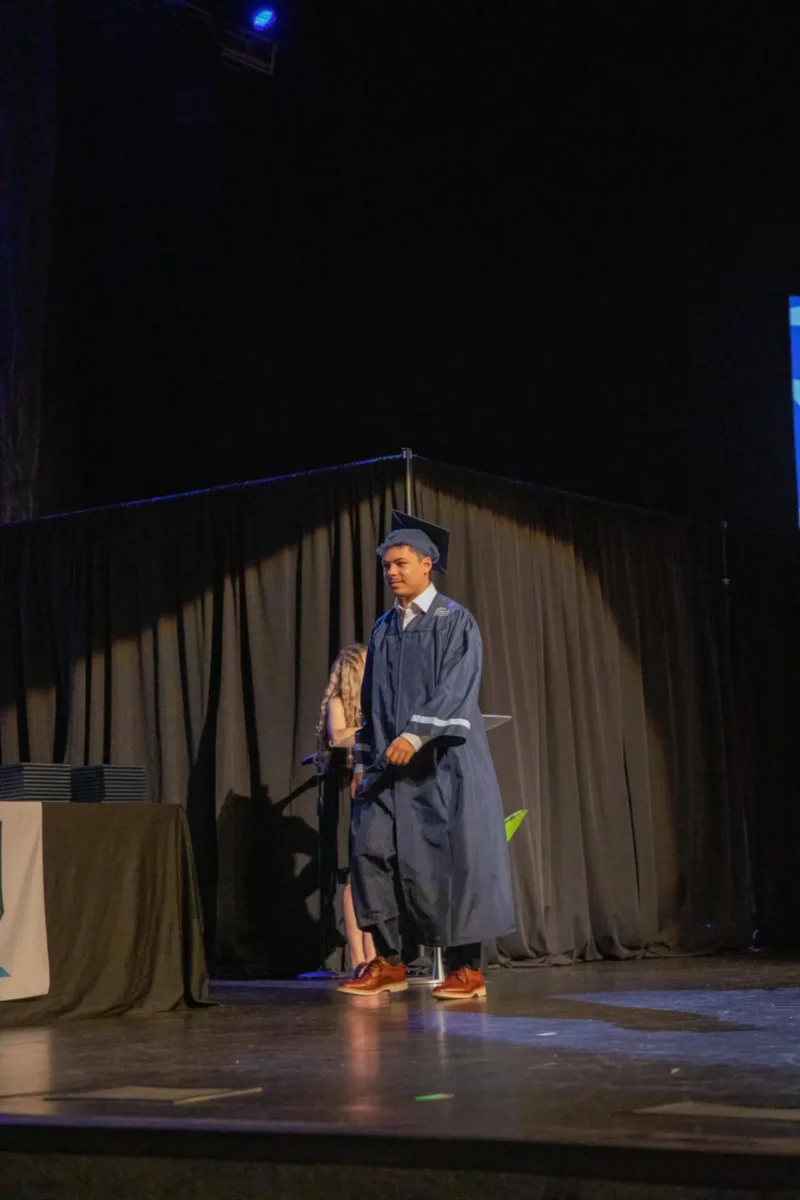 Student walking up to receive his diploma