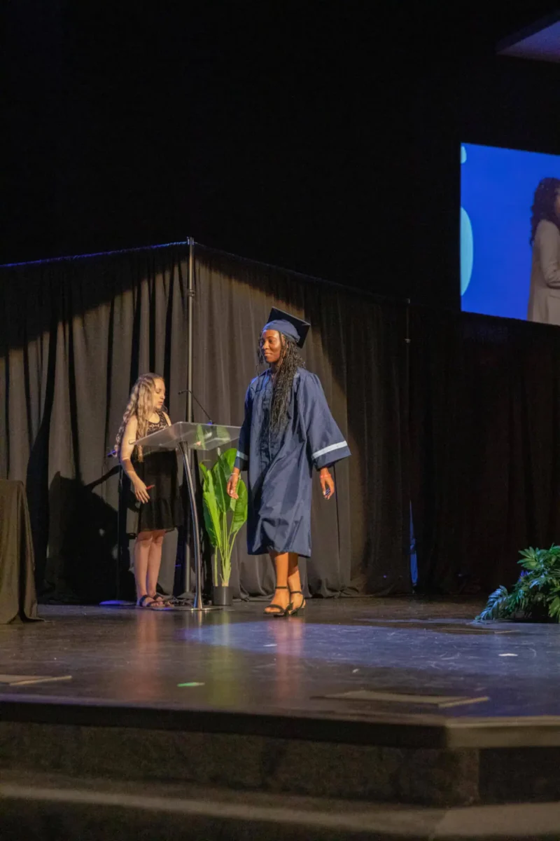 Student walking up to receive her diploma