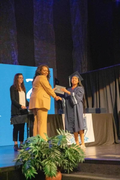 happy student with diploma and director