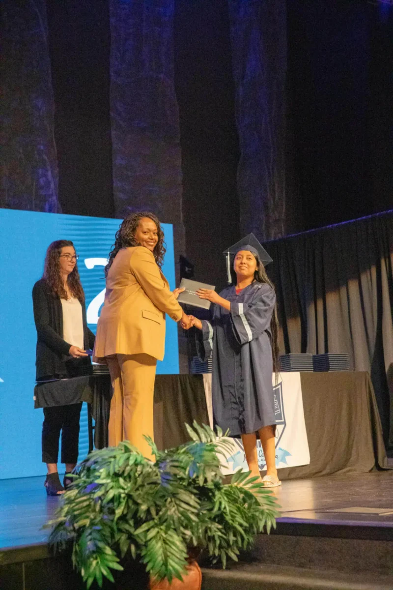 happy student with diploma and director