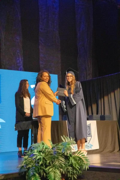 girl receiving the diploma from the director