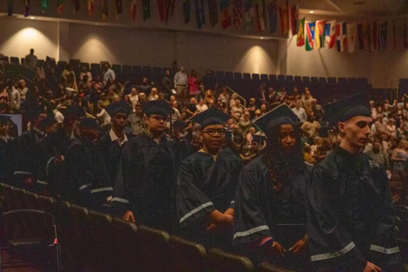 Graduated students lined up in the auditorium