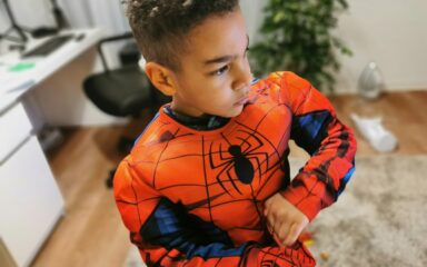 Kid wearing an spiderman costume