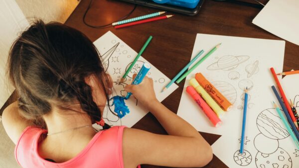 Student drawing in her home