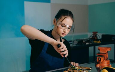 Student working on electronics in a technical training classroom.