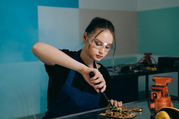 Student working on electronics in a technical training classroom.