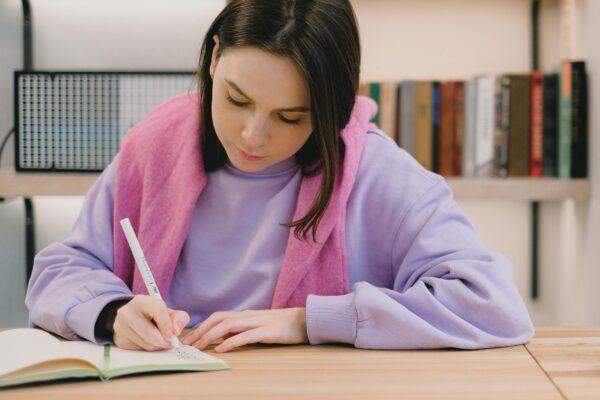 student writing in a notebook