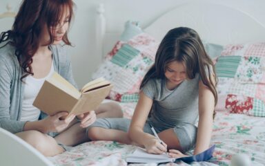 girl writing on a book