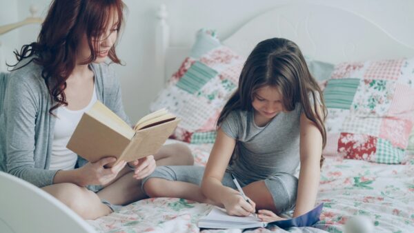 girl writing on a book